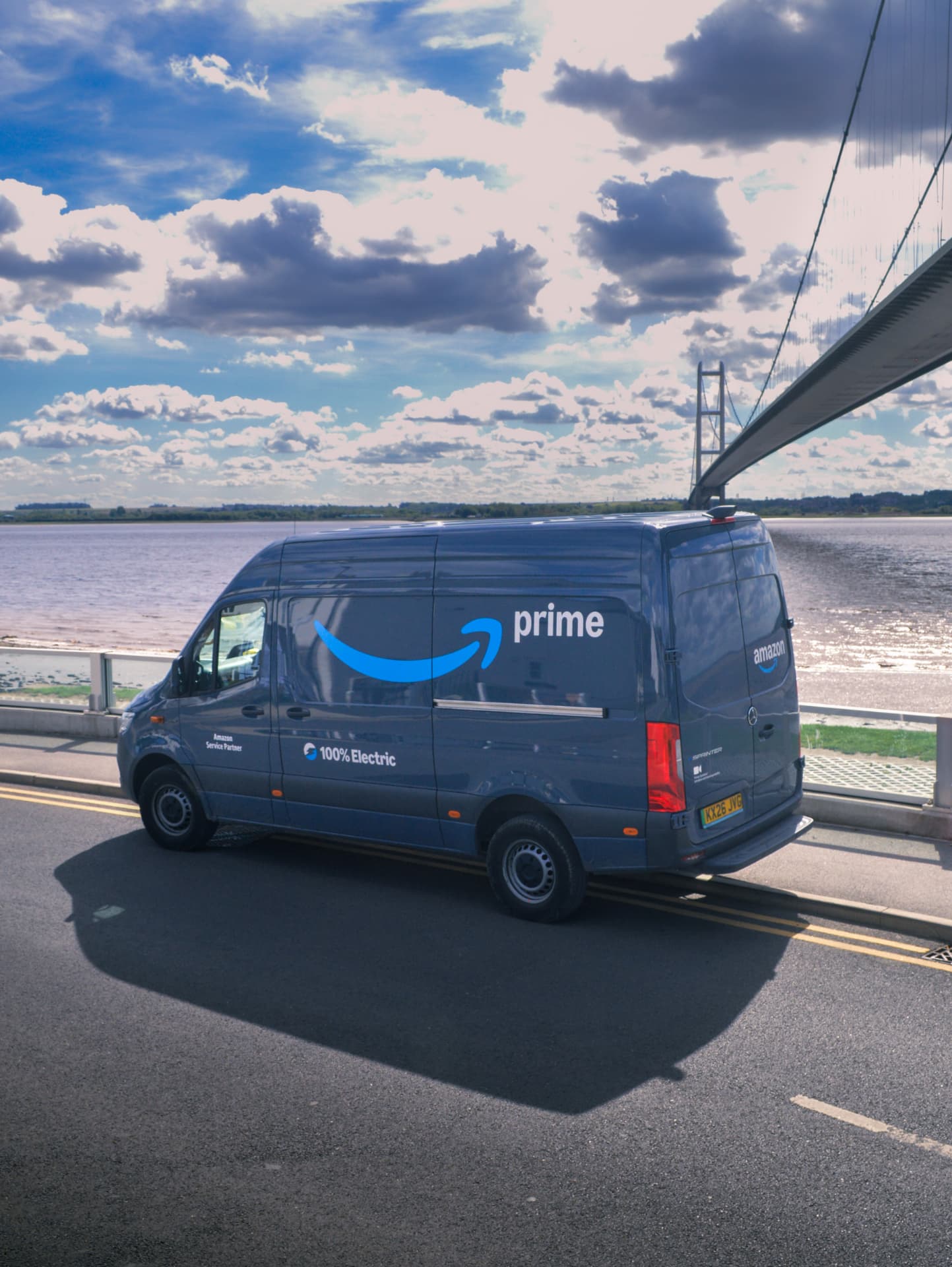 A depot supervisor talking with a delivery driver beside a van