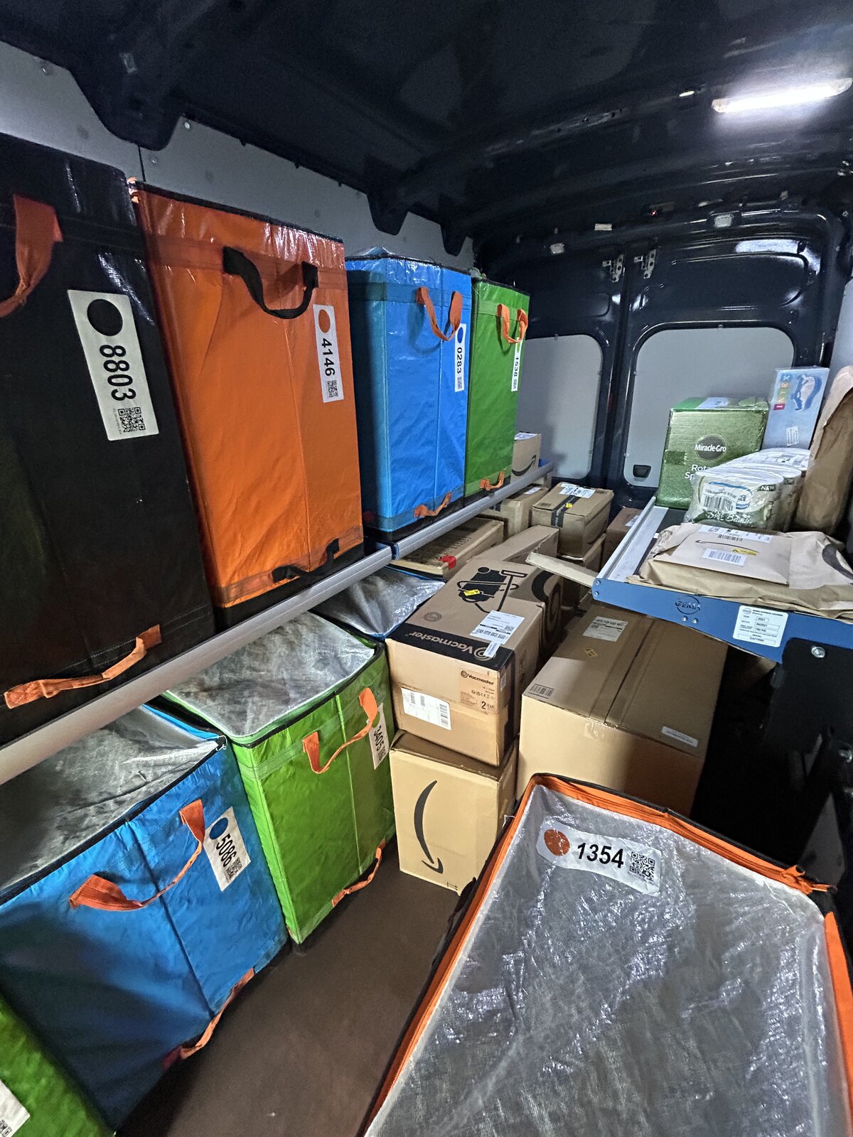 Cardboard parcels stacked neatly inside a delivery van
